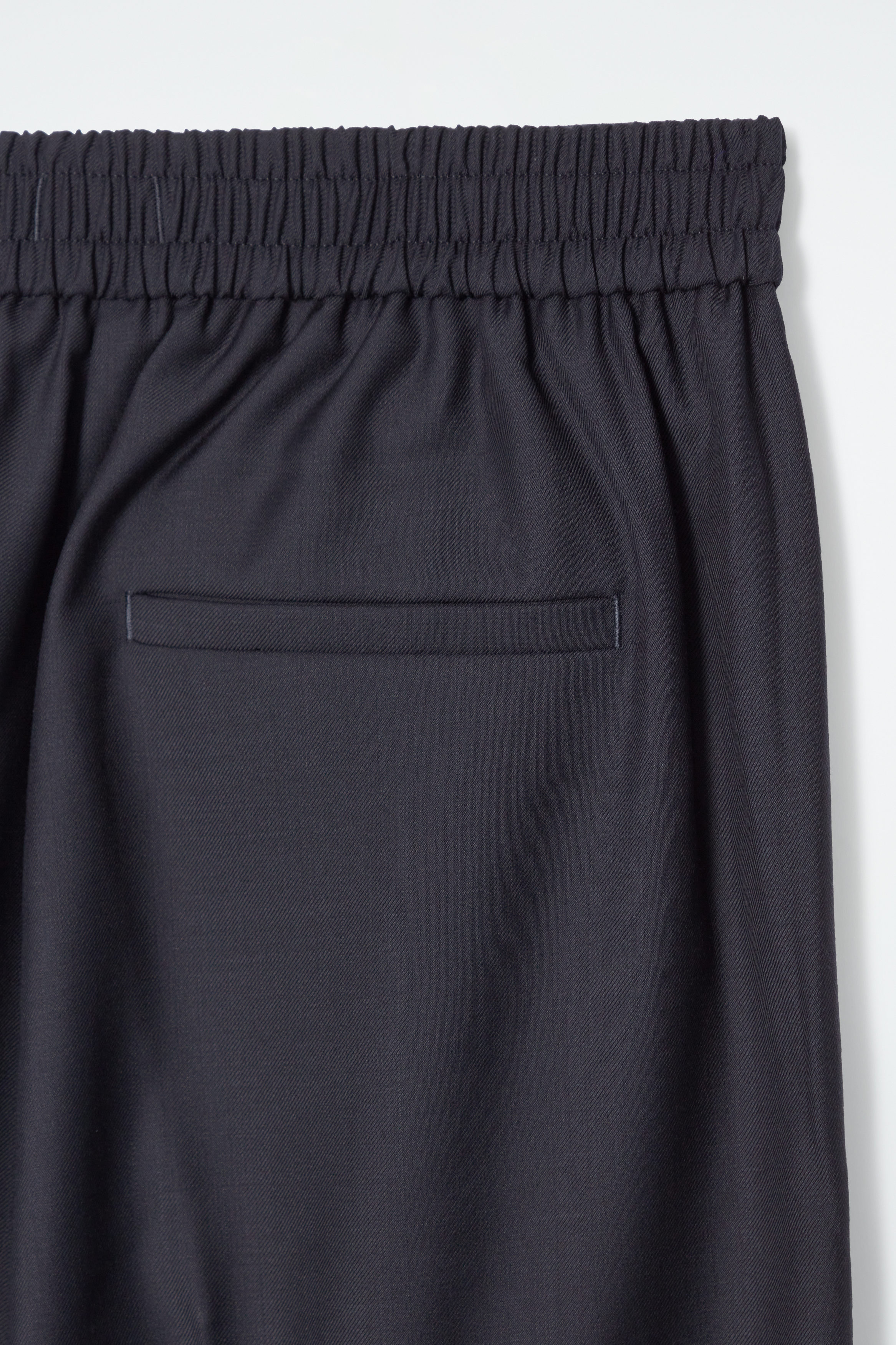 REGULAR ELASTICATED WOOL STRAIGHT-LEG TROUSERS - BLACK | COS